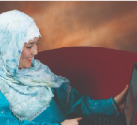 middle eastern woman holding a laptop